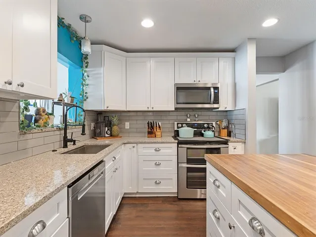a kitchen with a sink stove and microwave