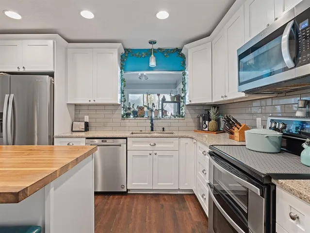 a kitchen with a sink stove and refrigerator