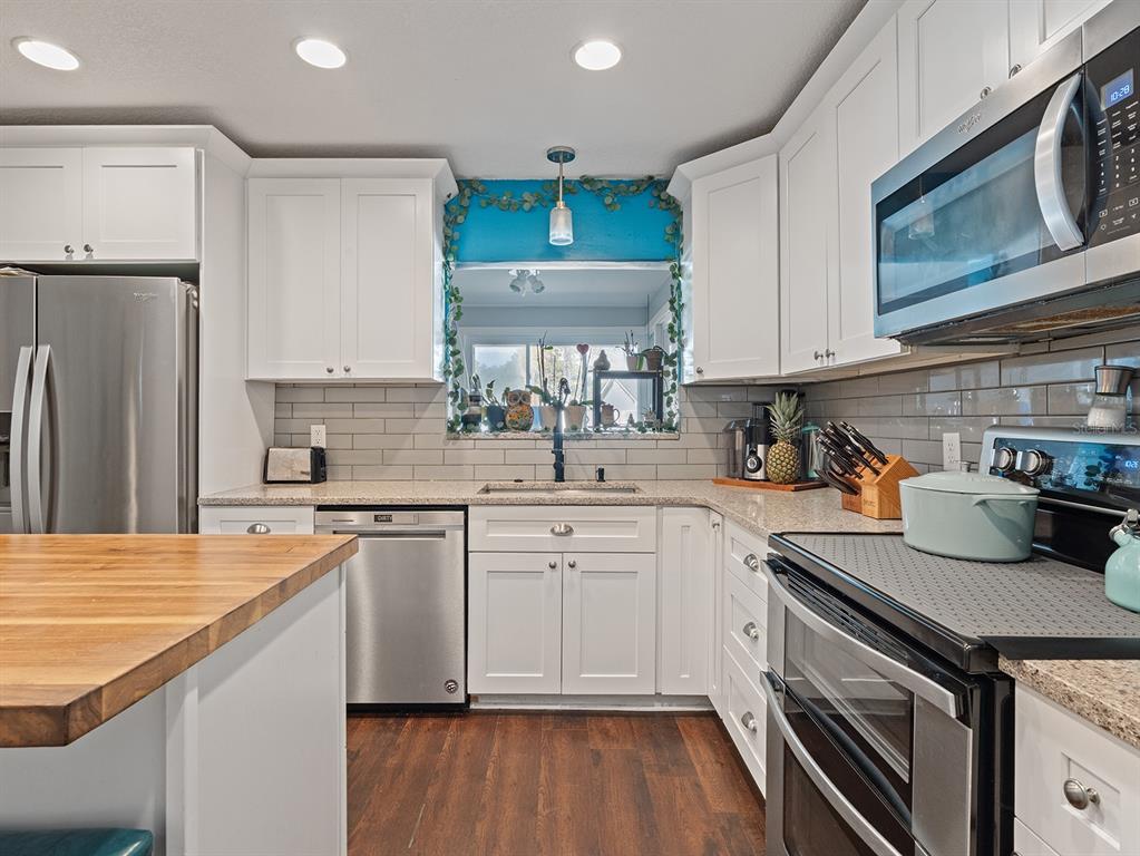1360 Via Villanova Way Winter Springs, FL 32708 - Photo 10 of 32 a kitchen with a sink stove and refrigerator