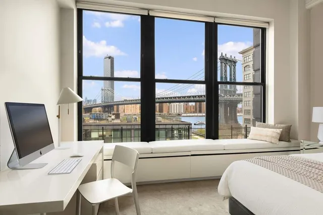 a bedroom with a large bed and a large window