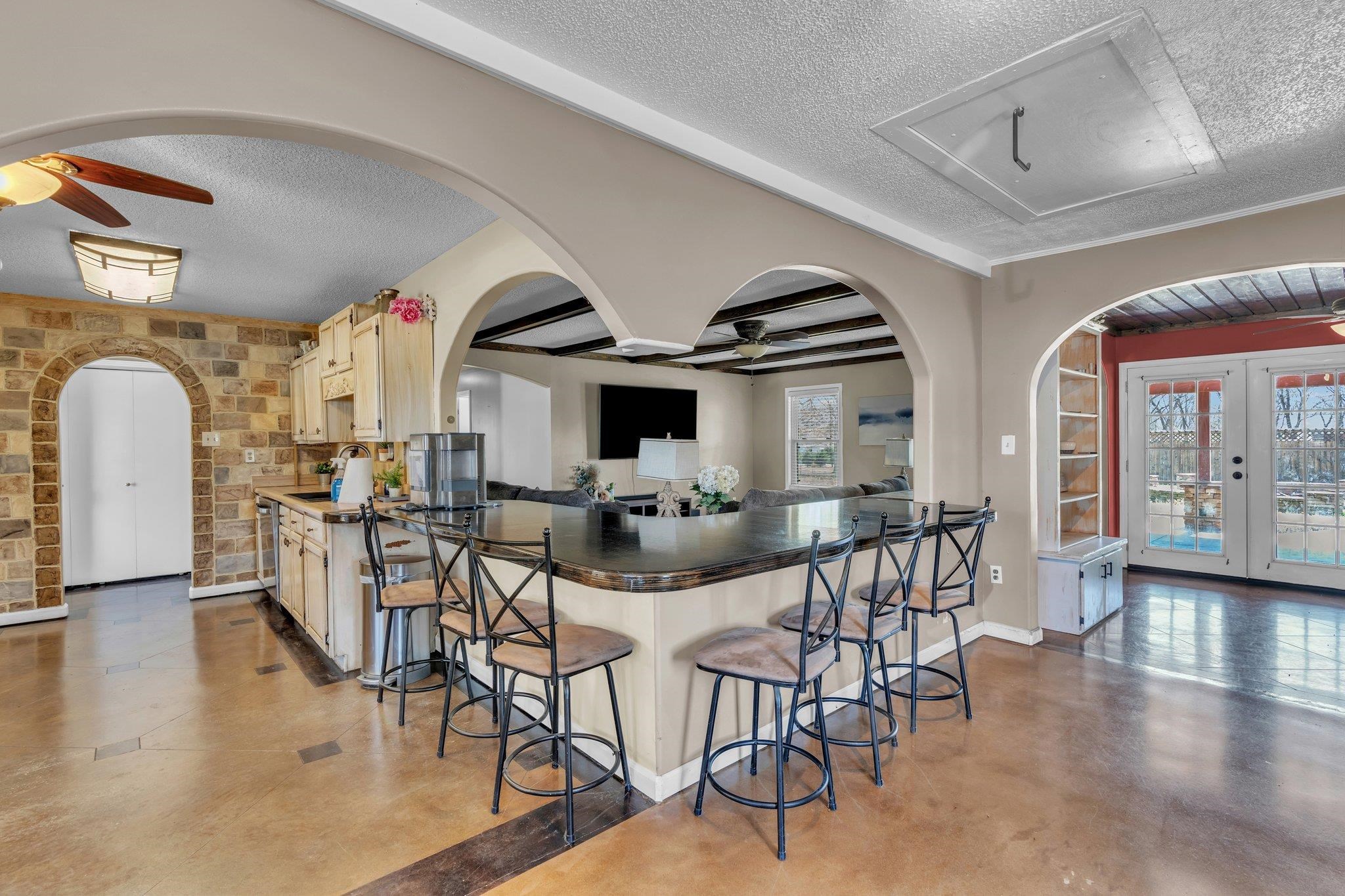 1818 Walnut Grove Road Burlison, TN 38015 - Photo 8 of 39 Kitchen with arched walkways, ceiling fan, finished concrete floors, enormous breakfast bar that will seat up to 12 people.