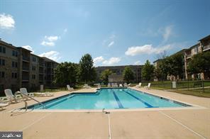 3000 Fountainview Circle, Unit 3411 Newark, DE 19713 - Photo 2 of 35 a view of a swimming pool with an outdoor space and seating area