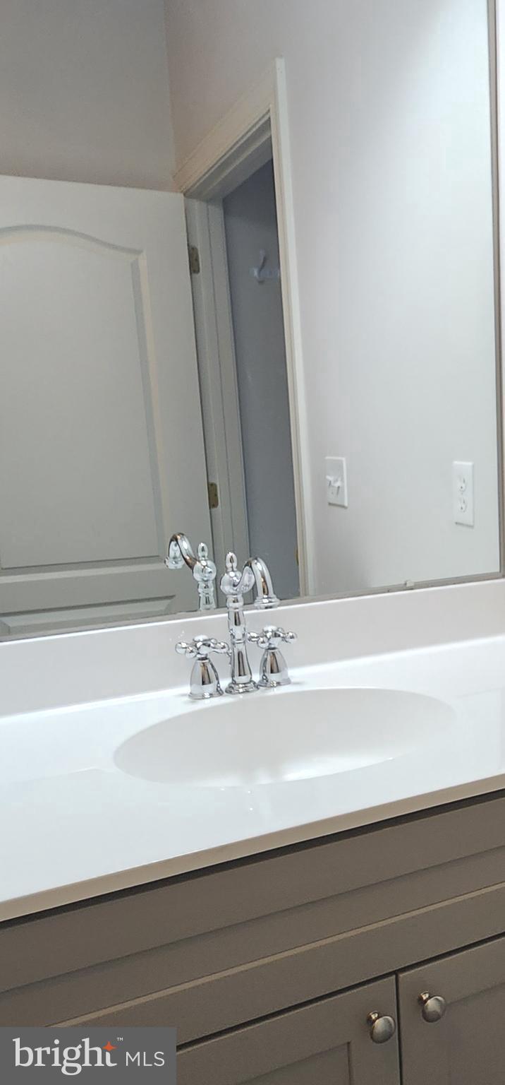 3000 Fountainview Circle, Unit 3411 Newark, DE 19713 - Photo 27 of 35 a bathroom with a sink and a mirror