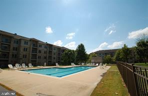 3000 Fountainview Circle, Unit 3411 Newark, DE 19713 - Photo 3 of 35 a view of a swimming pool with a yard and wooden fence