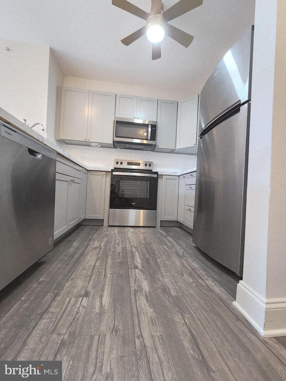 3000 Fountainview Circle, Unit 3411 Newark, DE 19713 - Photo 10 of 35 a kitchen with a refrigerator and a stove top oven