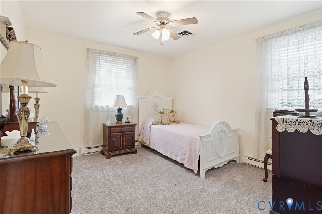 11016 Pridesville Road Amelia Court House, VA 23002 - Photo 35 of 54 Carpeted room featuring a ceiling fan, two windows