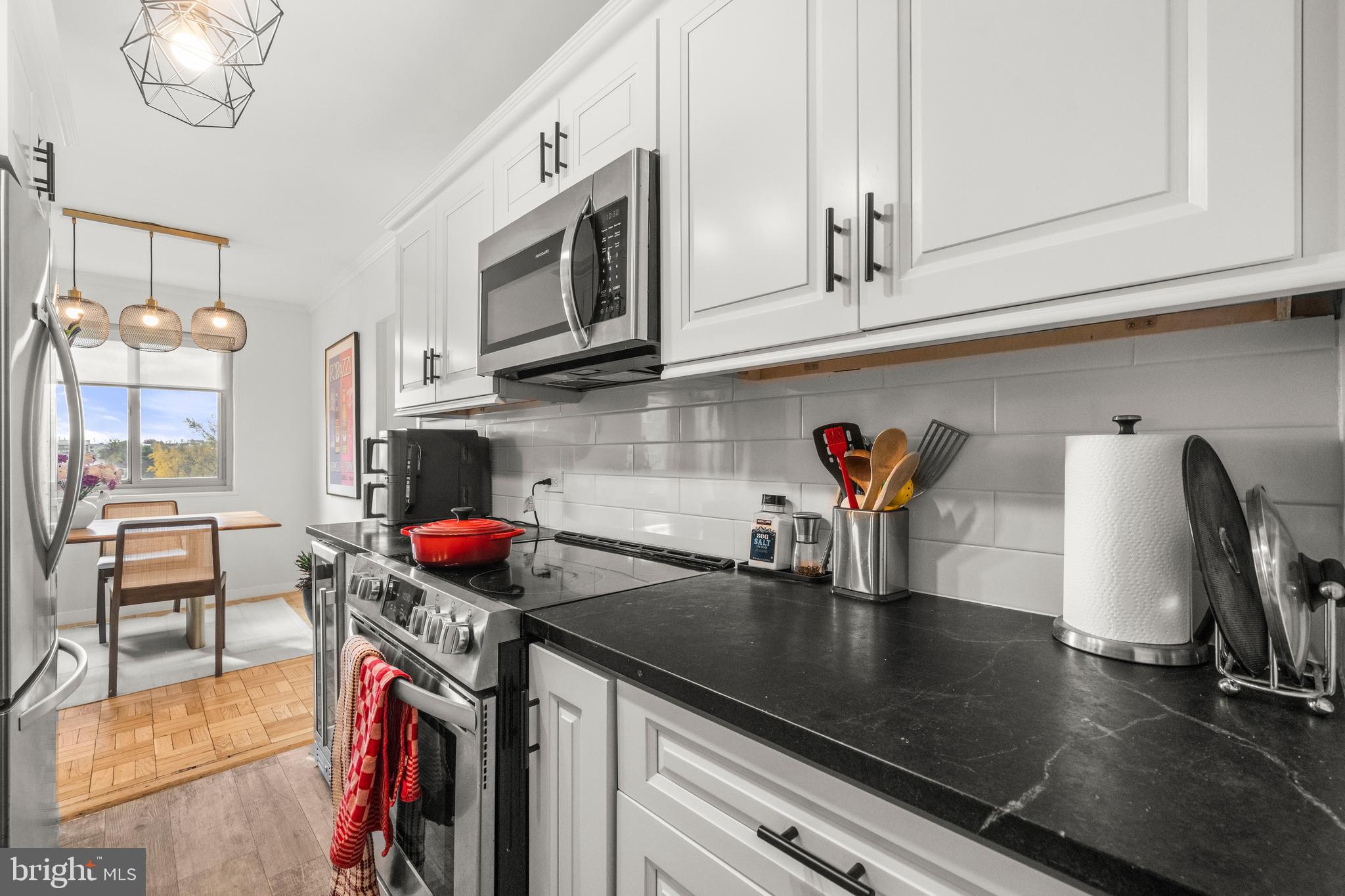 4600 Connecticut Avenue Northwest, Unit 810 Washington, DC 20008 - Photo 14 of 32 a kitchen with stainless steel appliances granite countertop a sink a stove and a wooden cabinets