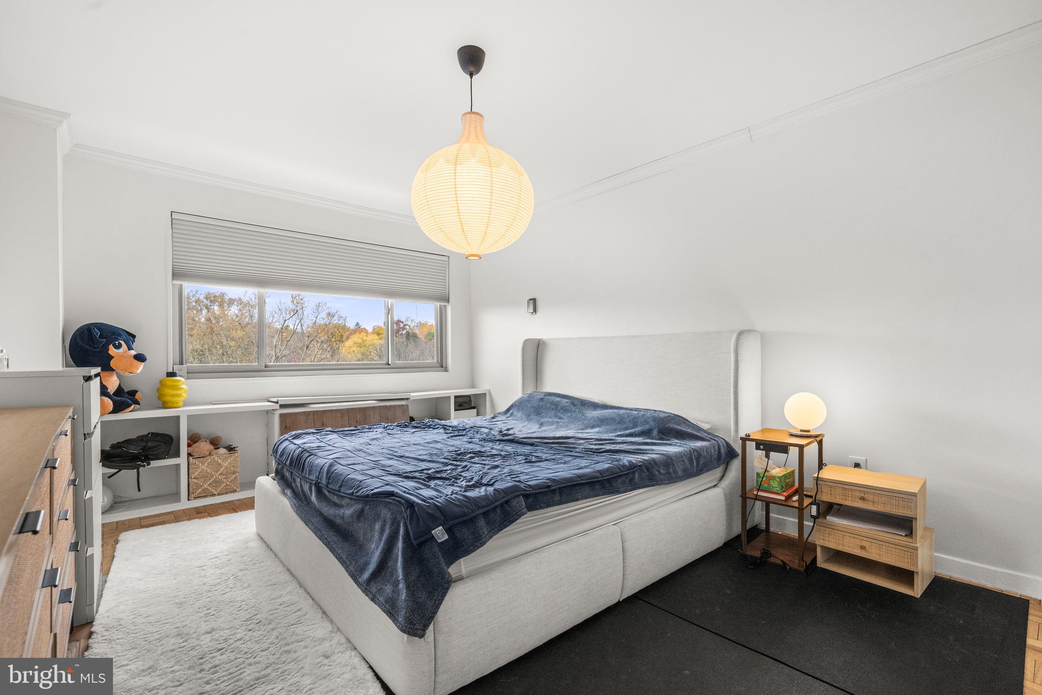 4600 Connecticut Avenue Northwest, Unit 810 Washington, DC 20008 - Photo 23 of 32 a bed room with a bed and a chandelier