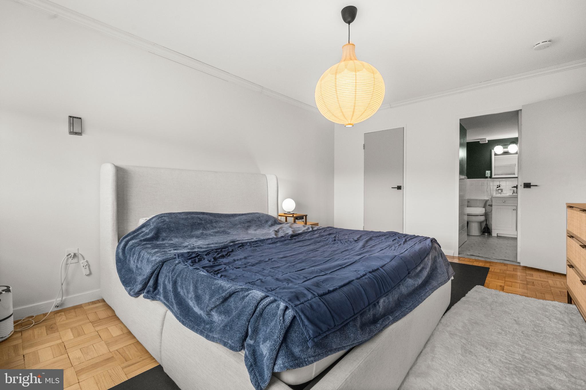 4600 Connecticut Avenue Northwest, Unit 810 Washington, DC 20008 - Photo 24 of 32 a spacious bedroom with a bed and a chandelier