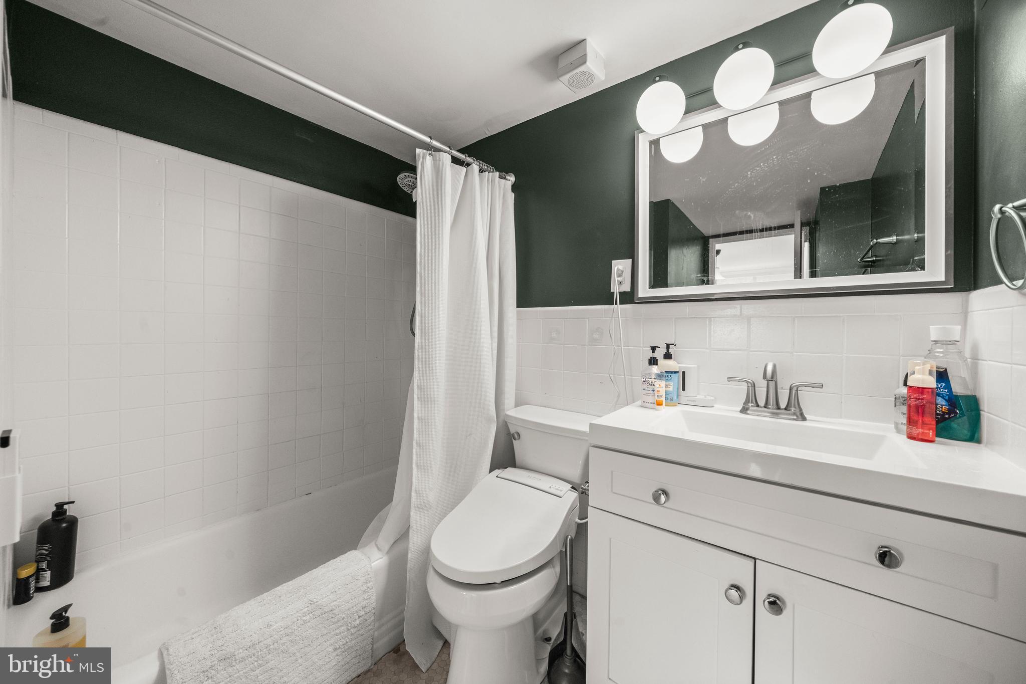4600 Connecticut Avenue Northwest, Unit 810 Washington, DC 20008 - Photo 25 of 32 a bathroom with a sink vanity mirror and toilet