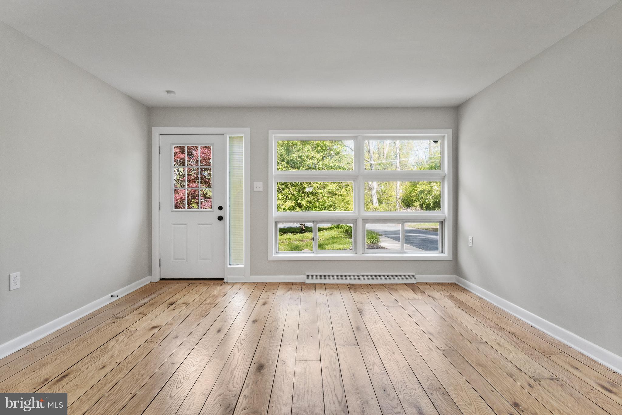 98 Wanner Road Reading, PA 19606 - Photo 11 of 30 a view of an empty room with wooden floor and a window