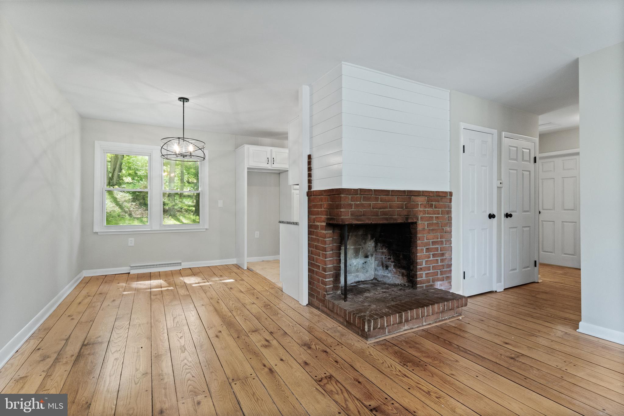 98 Wanner Road Reading, PA 19606 - Photo 13 of 30 a view of an empty room with wooden floor fireplace and a window