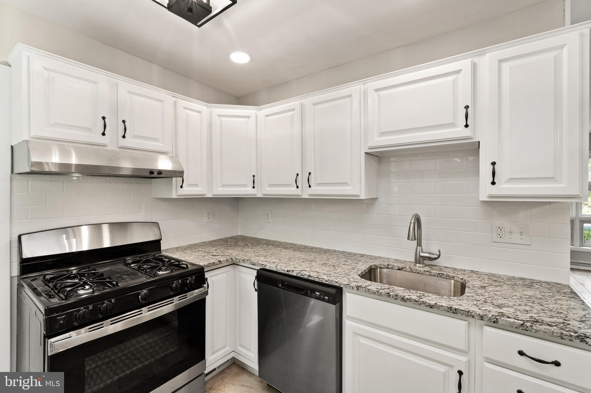 98 Wanner Road Reading, PA 19606 - Photo 16 of 30 a kitchen with stainless steel appliances granite countertop white cabinets and a stove top oven