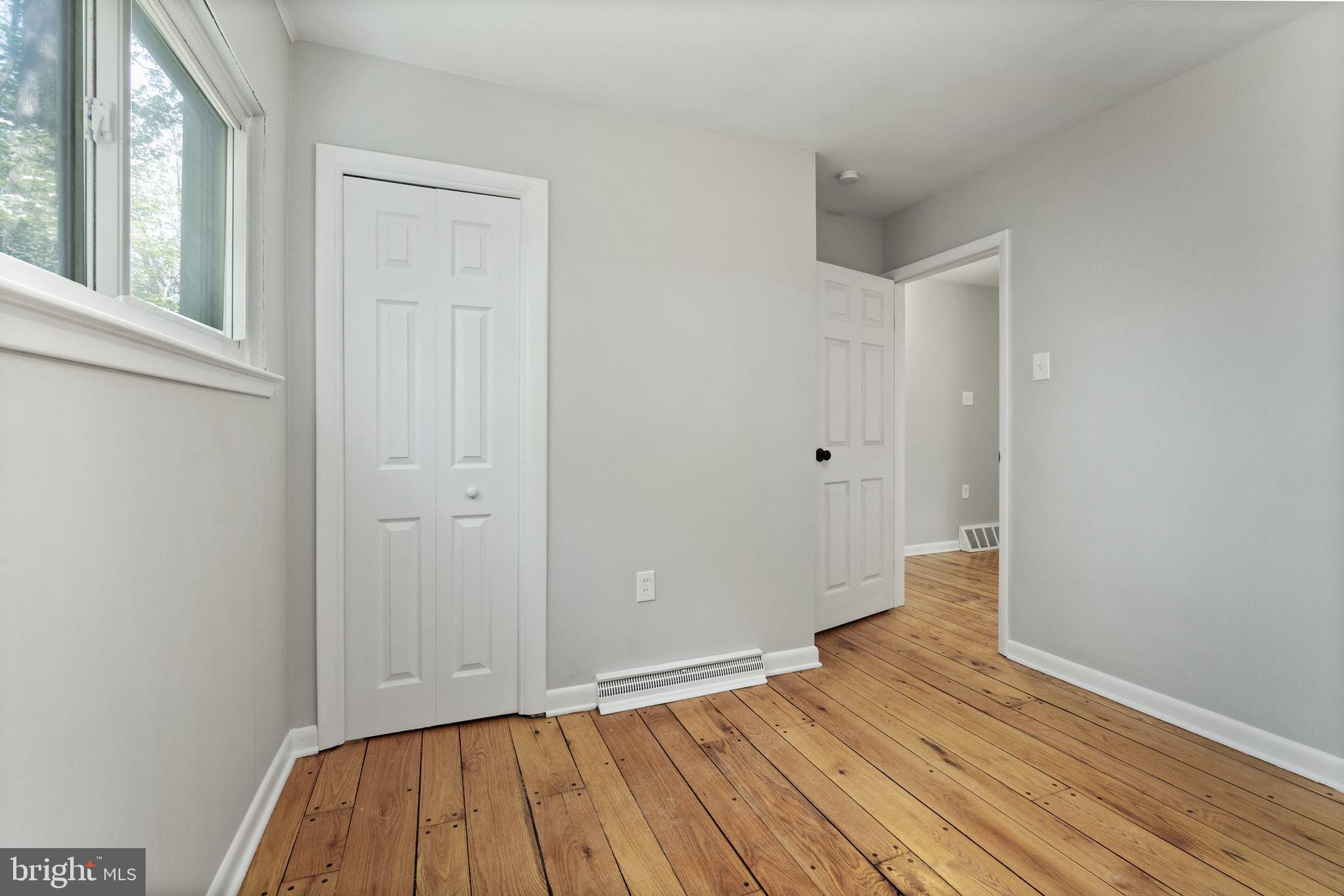 98 Wanner Road Reading, PA 19606 - Photo 23 of 30 a view of an empty room with wooden floor and a window
