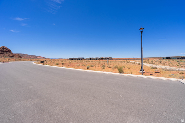 3306 South Endless Trail, Unit 33 Hurricane, UT 84737 - Photo 2 of 27 Paved street featuring a curved design, street light, and undeveloped land