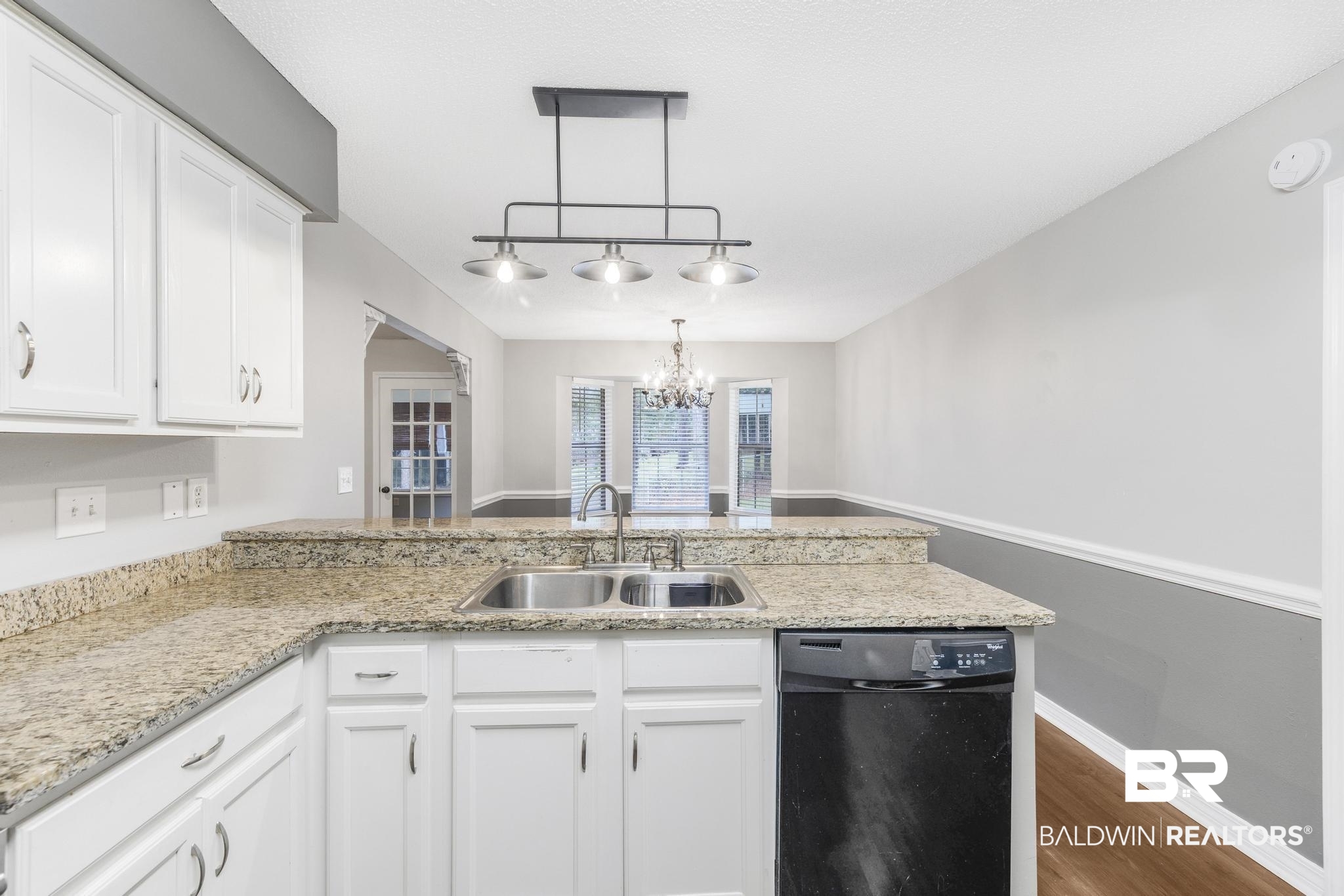 140 Hope Drive Daphne, AL 36526 - Photo 13 of 54 Kitchen with dishwasher, a peninsula, rail lighting, white cabinetry, and a chandelier