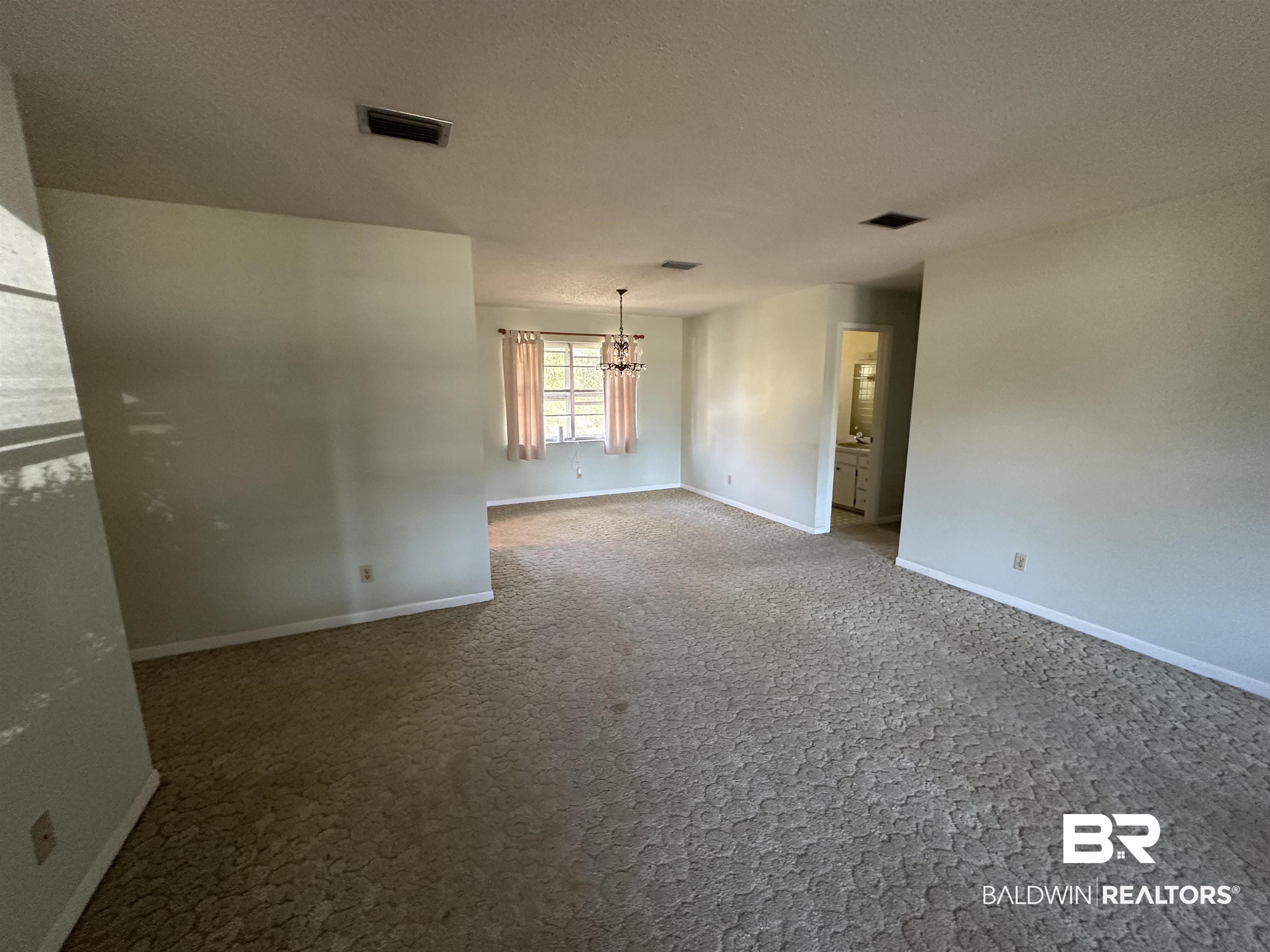 1 Yupon Circle Foley, AL 36535 - Photo 20 of 30 Carpeted spare room with hanging lights and a textured ceiling