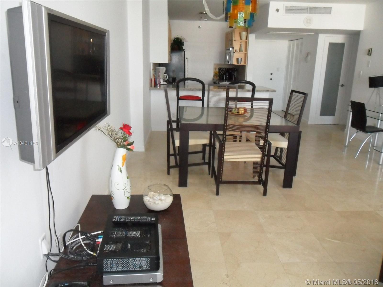100 Lincoln Road, Unit 1243 Miami Beach, FL 33139 - Photo 2 of 12 a dining room with furniture and wooden floor