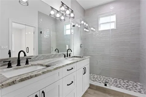 a bathroom with a sink a light fixture and a mirror