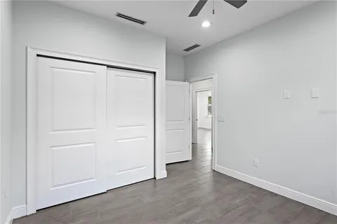 an empty room with wooden floor and cabinet