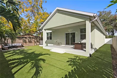 a view of a house with backyard porch and sitting area