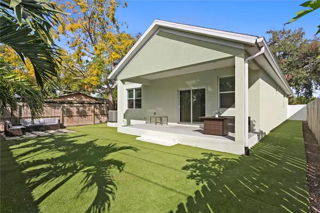 a view of a house with backyard porch and sitting area