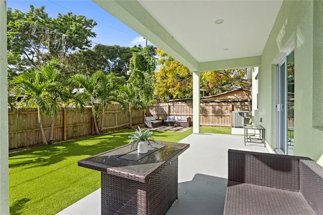 a house view with a sitting space and garden