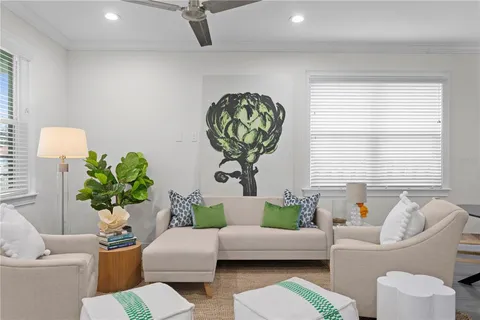a living room with furniture flowerpot and window