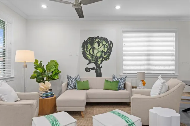a living room with furniture flowerpot and window