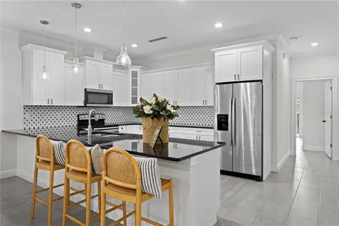 a kitchen with stainless steel appliances a refrigerator and a stove