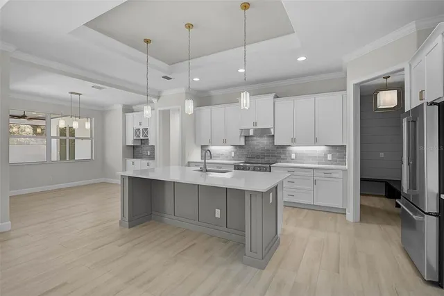a kitchen with kitchen island a sink stainless steel appliances and cabinets