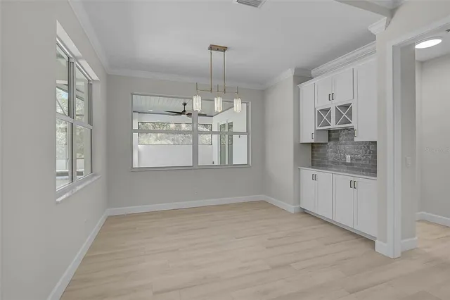 a view of an empty room with a kitchen