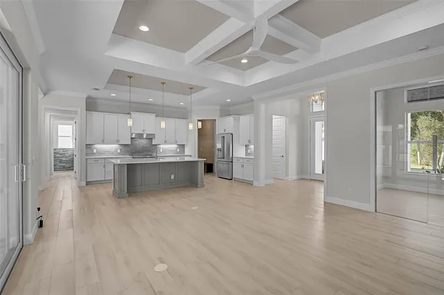 a kitchen with white cabinets and a sink