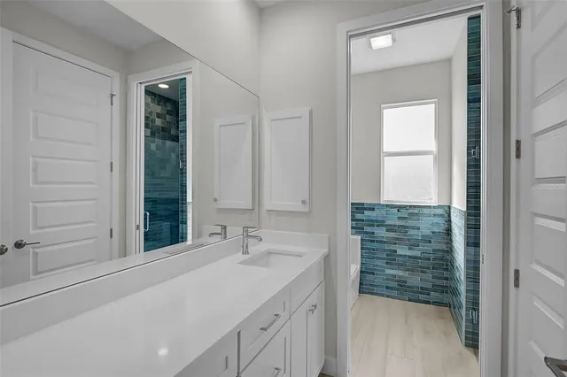 an empty room with wooden floor and door