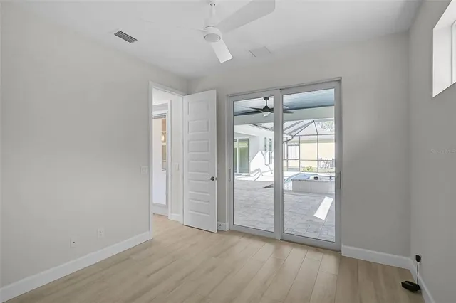 wooden floor in an empty room with a window