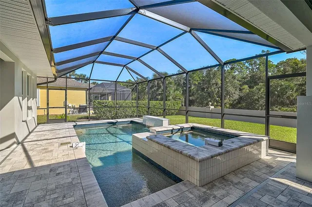 an aerial view of residential houses with outdoor space and parking