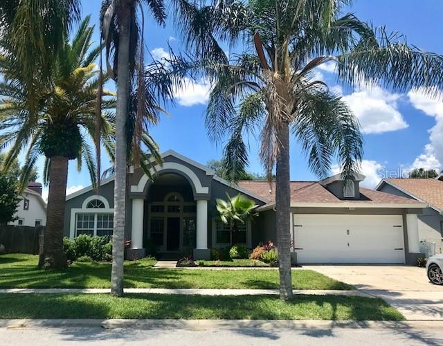 10106 Hermosillo Drive New Port Richey, FL 34655 - Photo 1 of 1 a view of a yard in front of a house with a garden