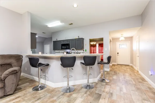 a view of a kitchen with a dining table and chairs