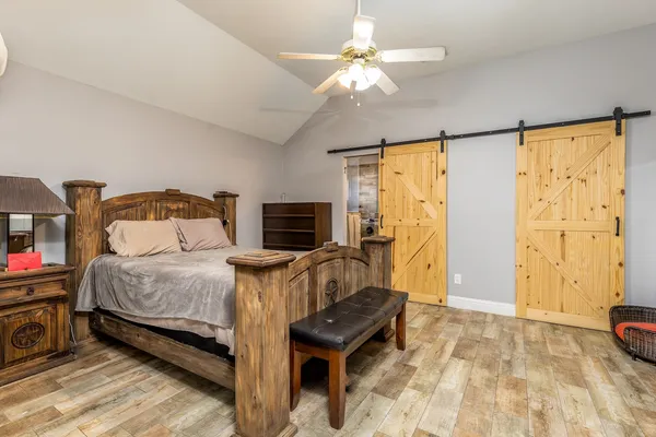 a bedroom with a bed and wooden floor