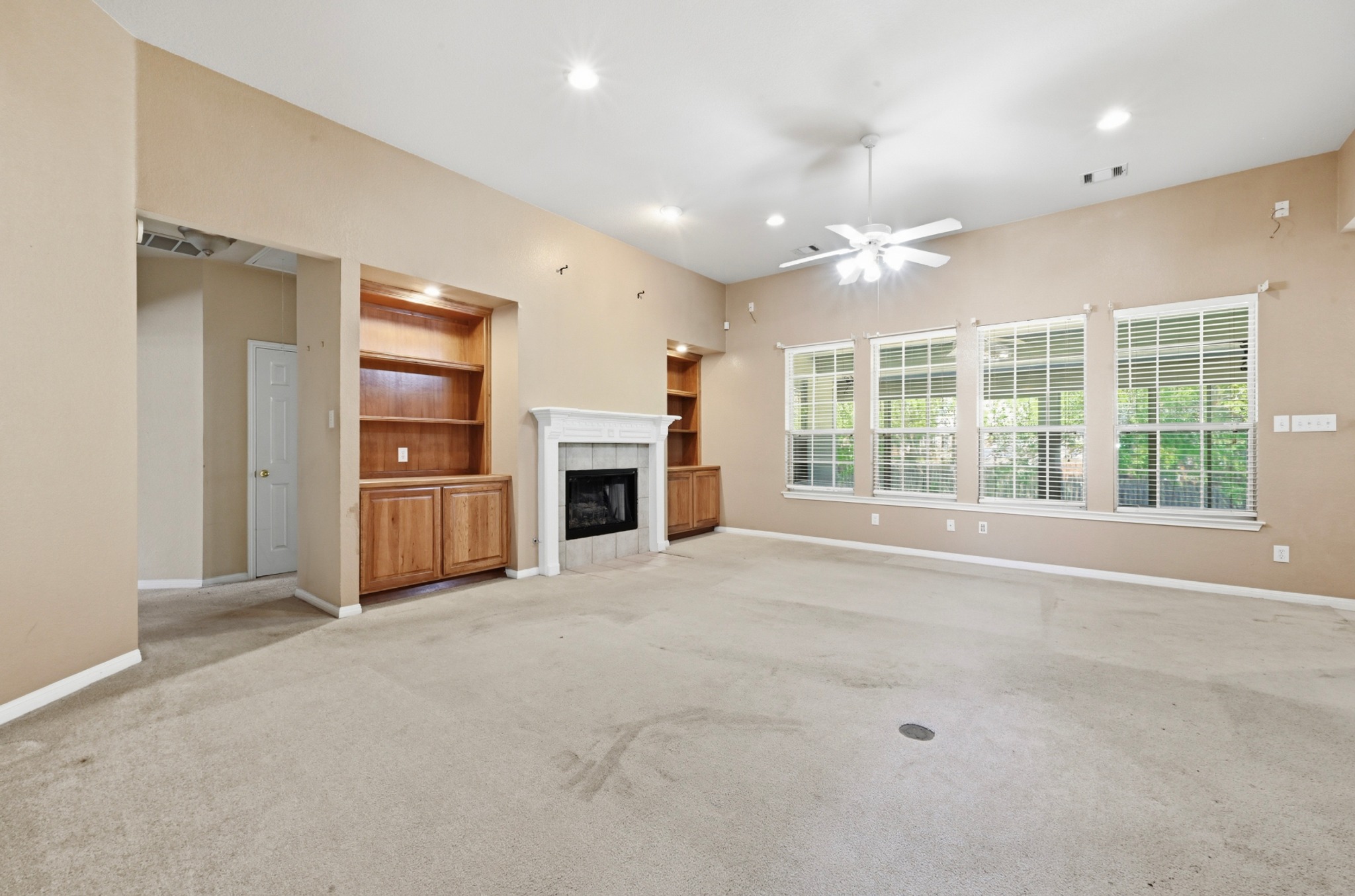 11500 Arbor Downs Road Austin, TX 78748 - Photo 11 of 40 Built in shelving, gas fireplace, view into sunroom and back yard
