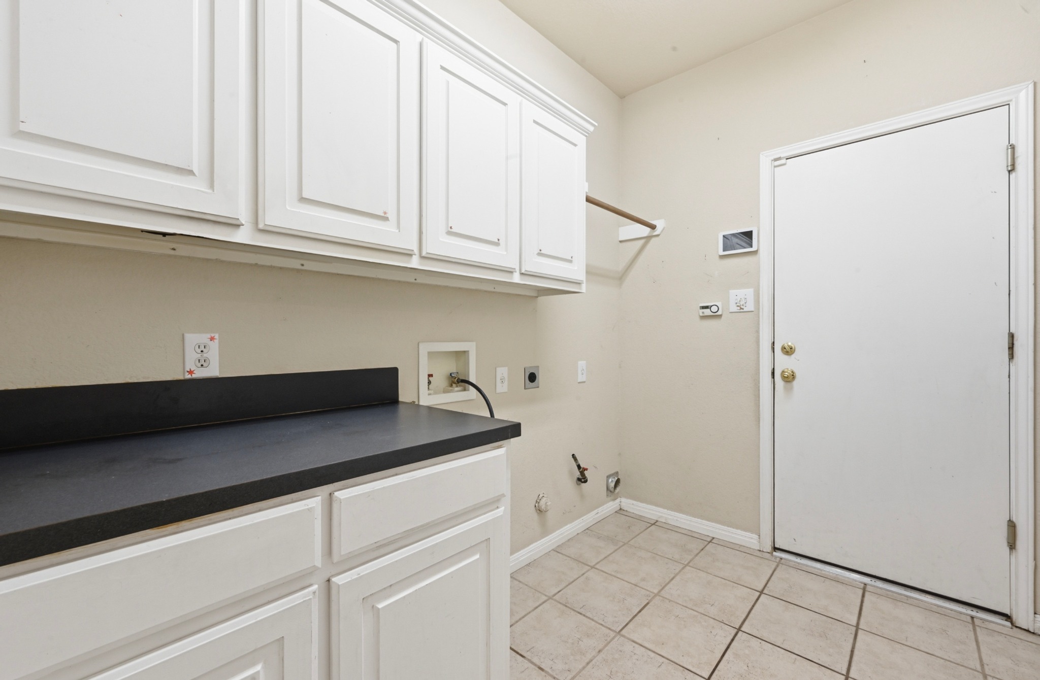 11500 Arbor Downs Road Austin, TX 78748 - Photo 35 of 40 Laundry Room with cabinet storage and garage access