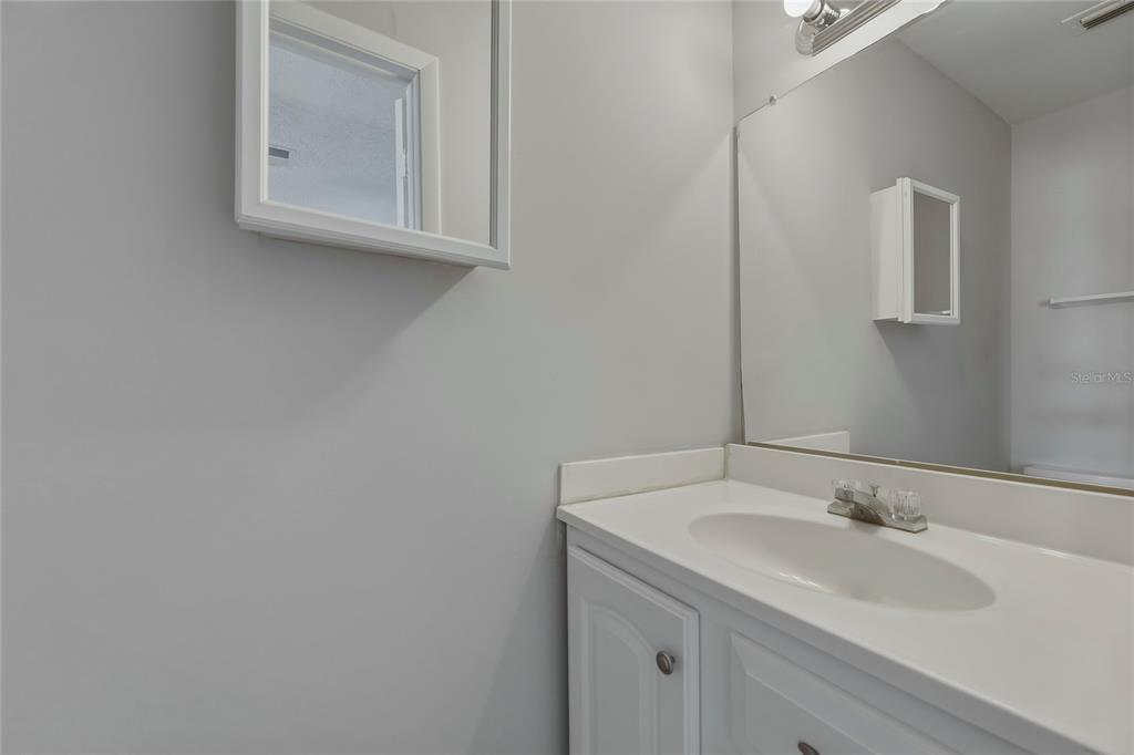 4799 Sisson Road Titusville, FL 32780 - Photo 7 of 23 a bathroom with a sink and a mirror
