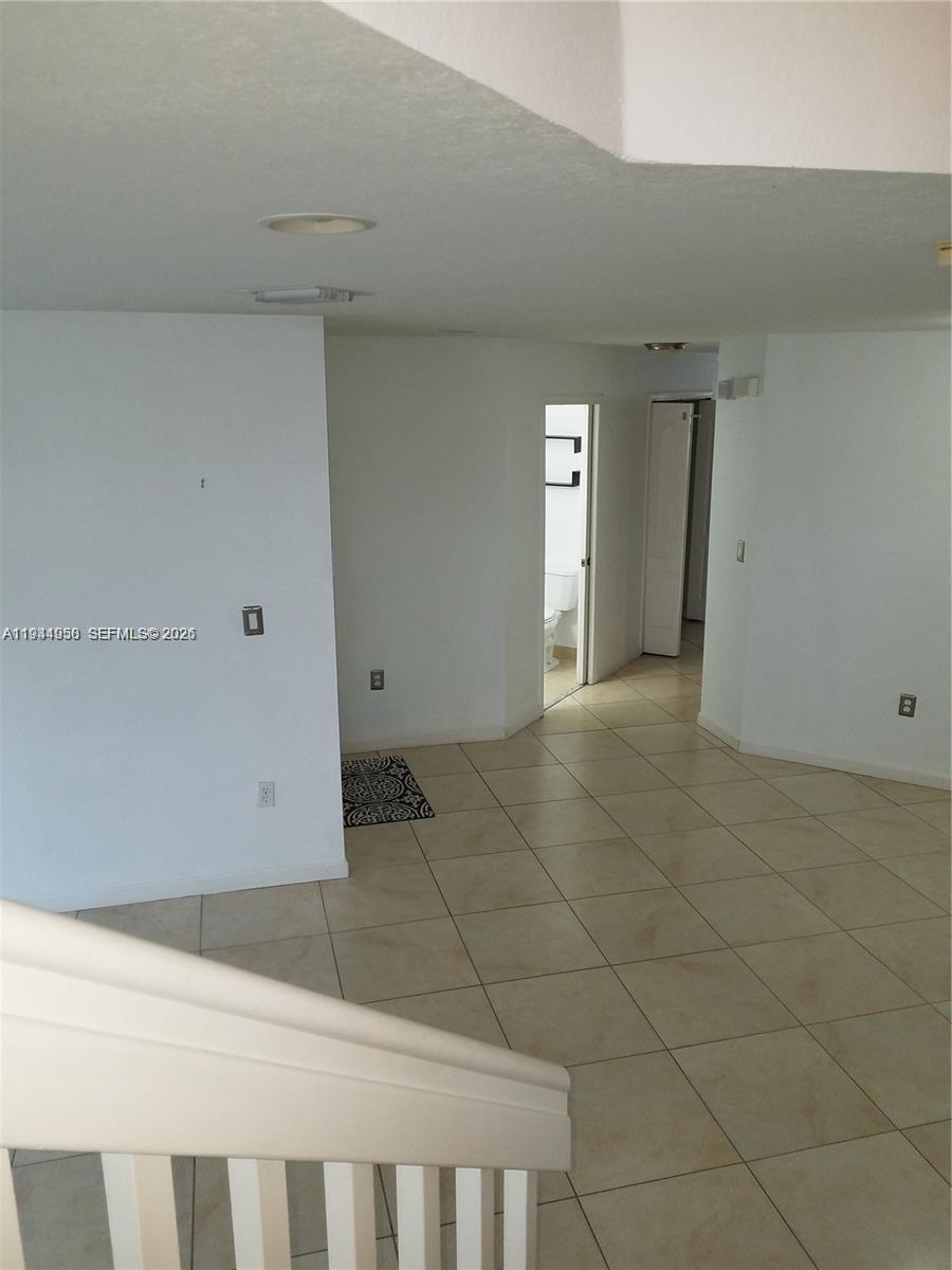 12902 Southwest 30th Street, Unit 133 Miramar, FL 33027 - Photo 5 of 16 a view of an empty room