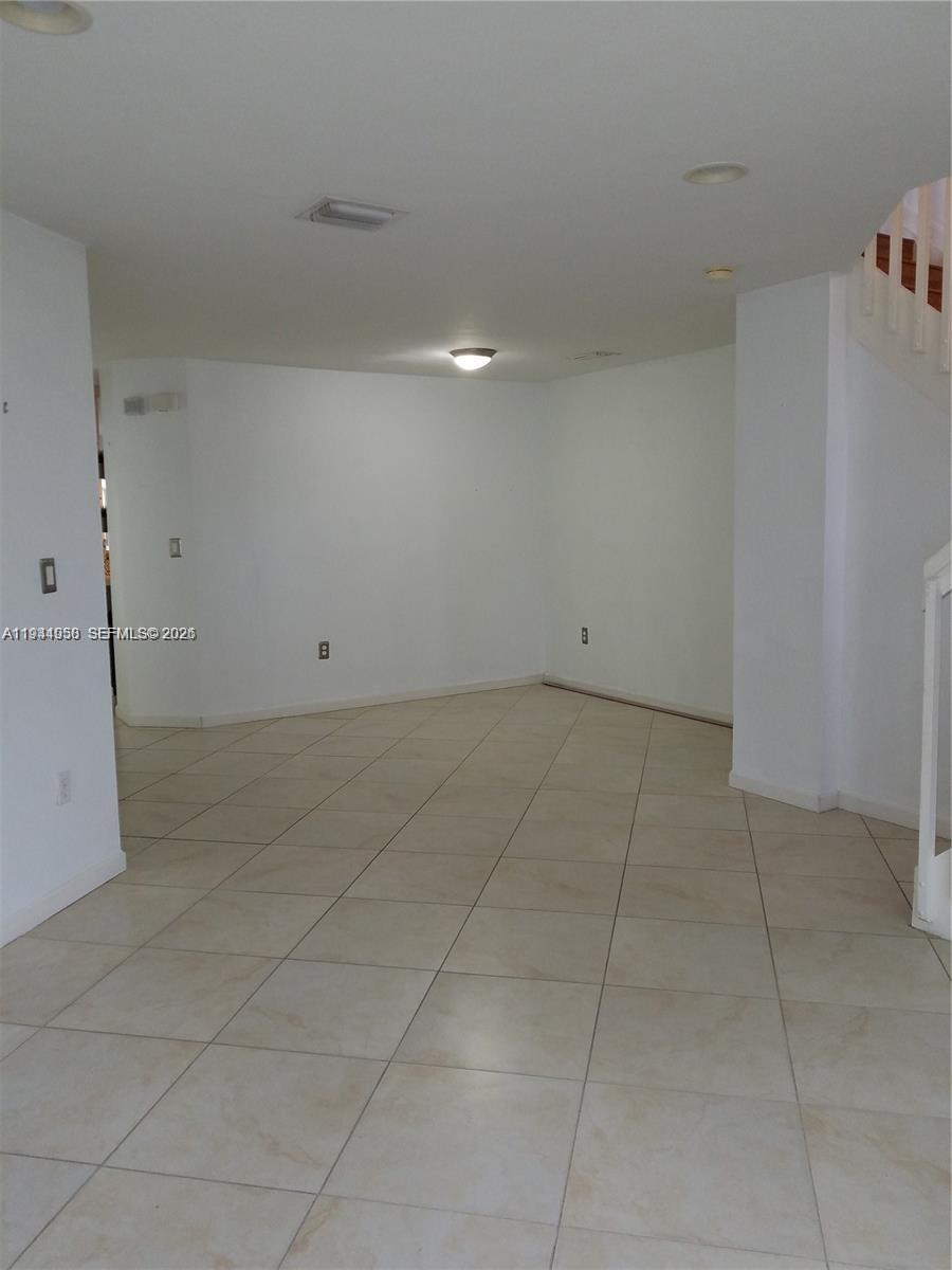 12902 Southwest 30th Street, Unit 133 Miramar, FL 33027 - Photo 6 of 16 a view of an empty room