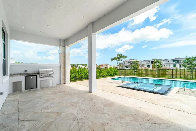 a view of a house with swimming pool and a porch with furniture