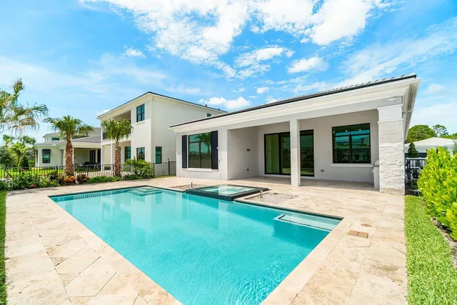 a view of a house with swimming pool and a yard