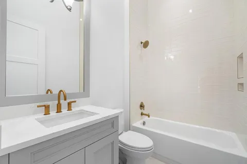 a bathroom with a toilet a sink and a bathtub