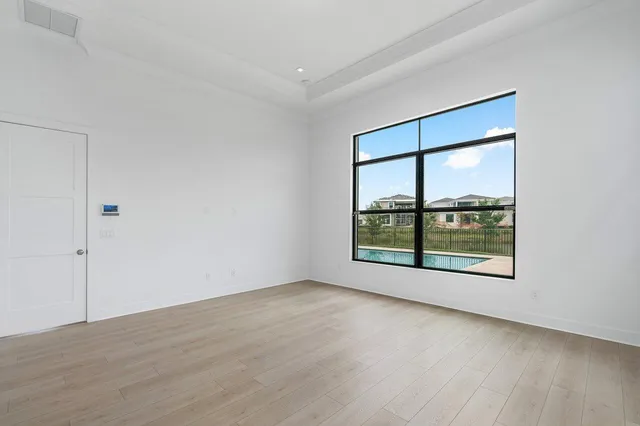 a view of swimming pool with palm trees