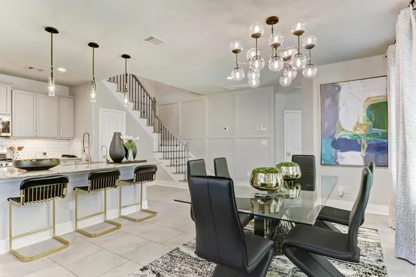 a view of a dining room with furniture a chandelier and wooden floor