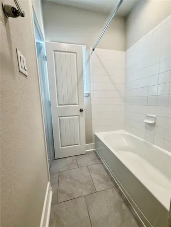 a bathroom with a bathtub and shower